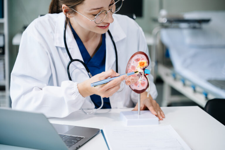 Confident young Caucasian female doctor in white medical uniform - Staffdna